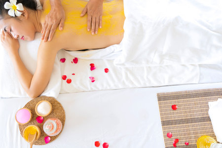Beautiful smiling woman with flowers resting in the spa before massage.の写真素材