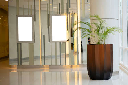 Blank advertising screen mockup in a hotel, reception counter in hotel, big banner on wall, mock-upの写真素材