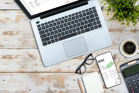 business accounting work with taxes and keyboard on white wooden desk top view mockupの写真素材