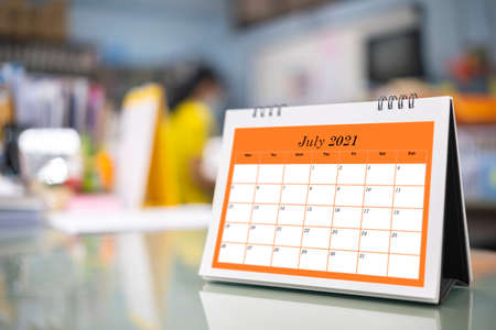 Desktop Calendar 2021 place on wooden office desk, for Planner to plan appointment each date, month and year on table. Calendar Background Concept.の写真素材