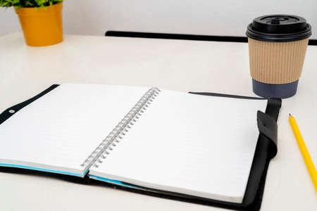 Empty open book, top view, coffee mug placed on the table.の写真素材