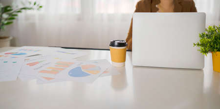 Young woman is working on a laptop sitting on the table, freelance business concept, banner size