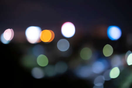 Abstract blue bokeh texture on black background. Night city street lights bokehの写真素材