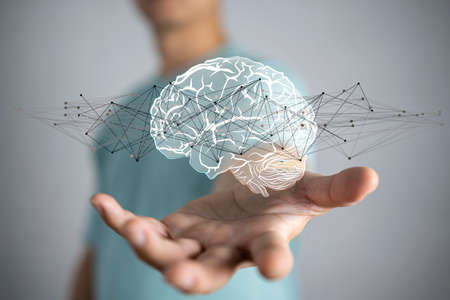 Businessman holding digital human brain with cell and neurons activity 3D renderingの写真素材