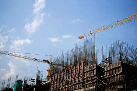 Engineer standing orders for construction crews to work on high ground heavy industry and safety concept over blurred natural background sunset pastelの写真素材
