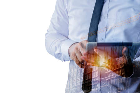 Double shot of construction worker holding tablet against a surreal city construction site...