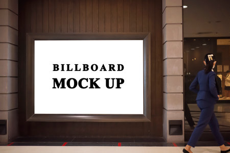 Mock up large blank vertical billboard placed near entrance and walkway in shopping mall, empty space for advertising or information, advertising conceptの写真素材