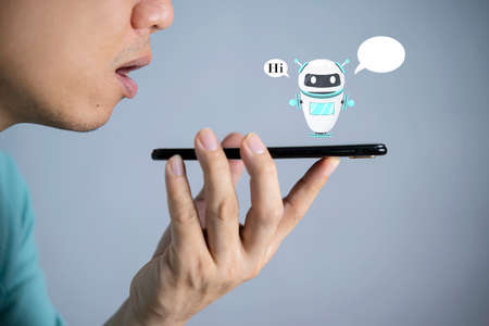 Digital chatbot, robot application, conversation assistant, AI Artificial Intelligence concept. Man using mobile smart phone, with digital chatbot on virtual screen and data in online networkの写真素材