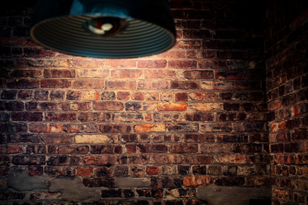 Illuminated grunge red brick wall background with copy spaceの写真素材