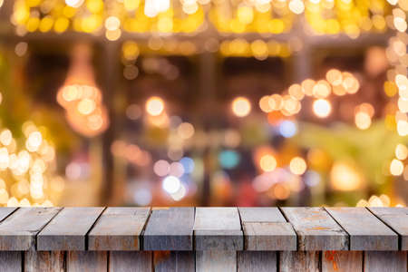 Empty wooden table in front of coffee shop abstract blur background It can be used for displaying or...