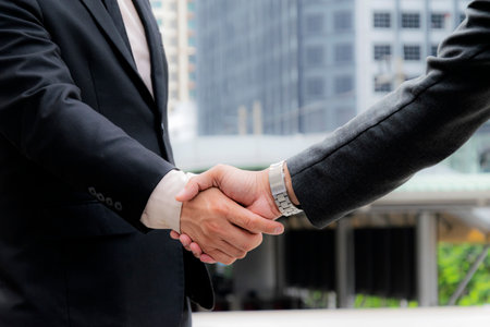 Business partnership meeting concept. Image businessmans handshake. Successful businessmen handshaking after good deal. Horizontal, blurred backgroundの写真素材