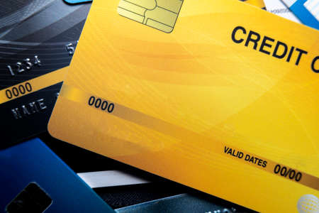 Credit card close up shot with selective focus for background. Lots of overlapping credit cardsの写真素材