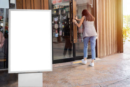 Mockup white promotion poster displayed on the front of the restaurant, coffee shop Promotion information for marketing announcements and detailsの写真素材