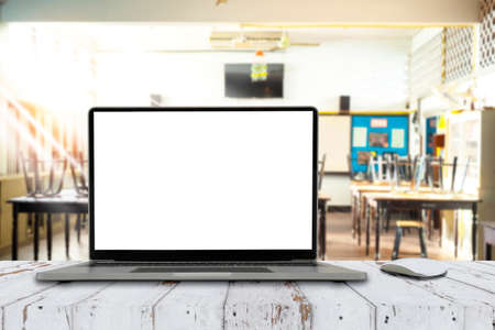 Front view of the laptop with blank screen on table in classroomの写真素材