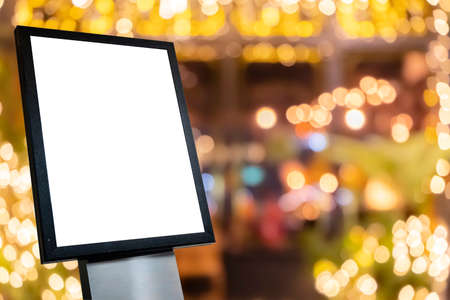 White poster mockup with black frame stand in front of blurred cafe restaurant background for displaying or presenting promotional product ideas.の写真素材