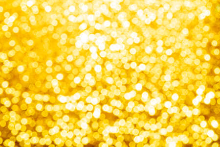 Gold light shiny bokeh abstract blur background with bright round defocus golden pattern, can use for Christmas festive decoration and any designの写真素材