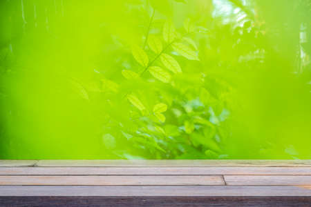 image of wooden table in front of abstract blurred background of outdoor garden lights. can be used...