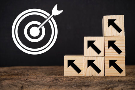Business achievement goal and objective target concept. Arrow which print screen on wooden cube.の写真素材