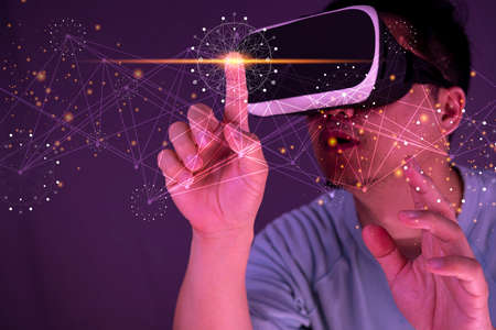 Experiencing virtual technology world. Mixed media. man with virtual reality glasses future technology conceptの写真素材