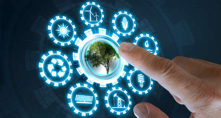 Businessman press tree button with virtual light in dark background, with icons energy sources for renewable, sustainable development. Ecology concept.の写真素材
