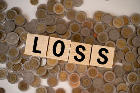 Wooden cubes with LOSS word on wooden table. Financial loss busines concept. Memory loss demetia mental health concept.の写真素材