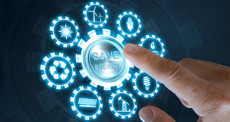 Businessman press save energy button with virtual light in dark background, with icons energy sources for renewable, sustainable development. Ecology concept.の写真素材