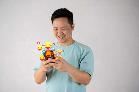 Social network sharing and commenting in the online community, Man hand holding smartphone and using application social media, social media concept, likes on social network coming from smartphone screenの写真素材