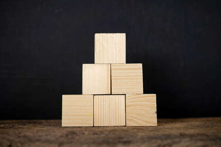Concept of growth in business,stack of wooden block on wooden board backgroundの写真素材