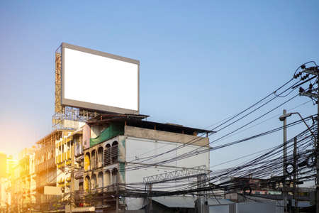 Blank billboard at twilight for advertisement.Installed on high rise buildings in Bangkok, atmosphere with electric poles and wires.の写真素材