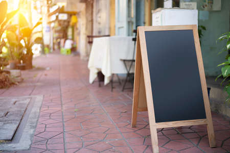 Restaurant sidewalk chalkboard sign board. empty black board (menu board) at a restaurant with space for textの写真素材
