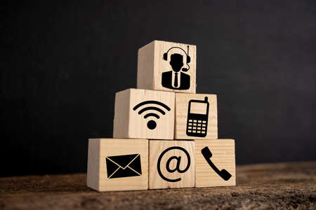 Contact us icon (phone, email, email, PR ) on wooden cube.Customer service and support.の写真素材