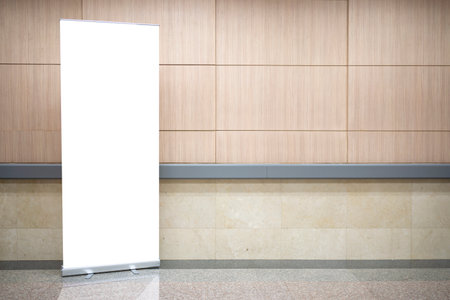 Blank roll up stand banner. Blank mockup for presentation isolated on wall background in hospital, hotel, airport.の写真素材