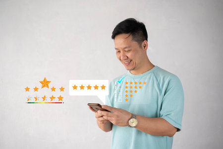Customer man hand pressing on smartphone screen with gold five star rating feedback icon and press level excellent rank for giving best score point to review the service , business conceptの写真素材