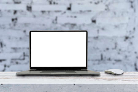 Mockup blank screen laptop on desk. Workspace with laptop and office supplies.の写真素材