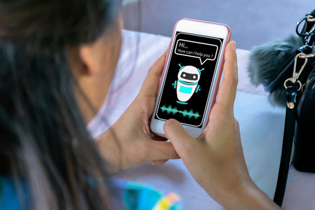 Businesswoman using a smartphone. online chatbot answering robot assistant on siteの写真素材