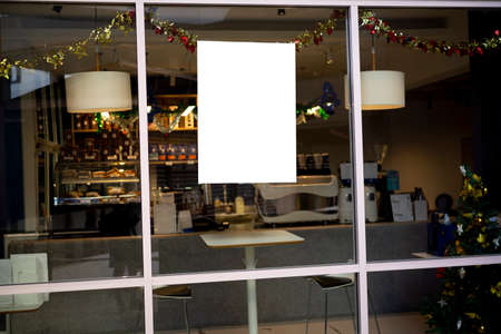 Mockup white paper or white promotion poster displayed on the front of the restaurant, coffee shop Promotion information for marketing announcements and detailsの写真素材