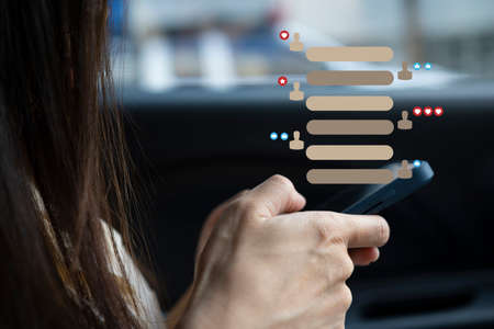 Women hand using smartphone typing, chatting conversation in chat box icons pop up. Social media maketing technology concept.Vintage soft color tone background.の写真素材