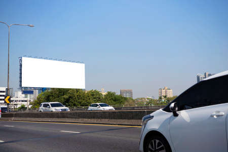 billboard blank on road in city for advertising background. for advertising background. Cars are traveling a lot.の写真素材