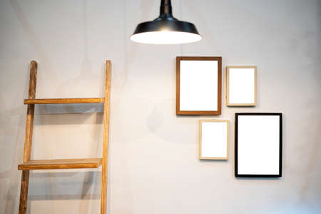 Cropped shot of stylish workspace with mock up frame, stationery in living room. Design composition of home interior.の写真素材