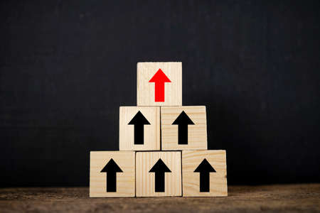 Ladder career path for business growth success process concept. Wood block stacking as step stair with arrow upの写真素材