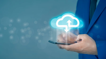Cloud computing concept - connect smart phone to cloud. Businessman or information technologist with cloud computing icon and smart phone.の写真素材