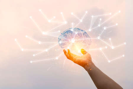 Abstract palm hands touching brain with network connections, innovative technology in science and communication conceptの写真素材