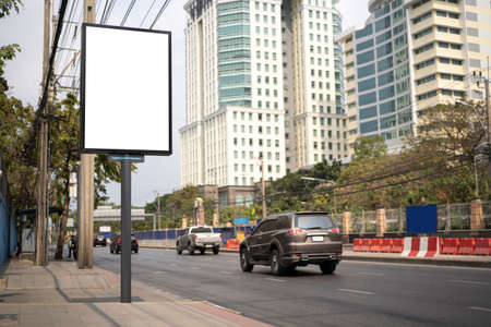 Billboard canvas mock up in city background, city street background. blank advertisement in the side of the streetの写真素材