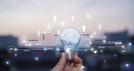 Businessman holding light bulb, abstract brain and icon digital marketing, strategy and growtn investment business target goal, media and technology. Creative brain business success strategy plan ideaの写真素材