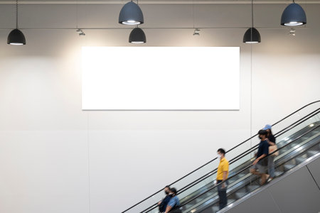 Blank horizontal big poster in public place. Billboard mockup near to escalator in an mall, shopping center, airport terminal, office building or subway station. 3D rendering.の写真素材