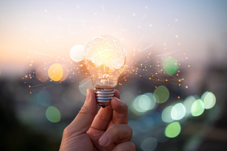 Businessman holding glowing lightbulb with drawing brain and connection line, creative thinking ideas and innovation concept.の写真素材