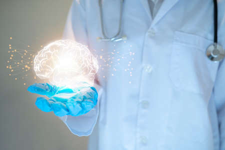 Doctor shows the brain of a person on a blue background. Support healthy of the brain concept design.の写真素材
