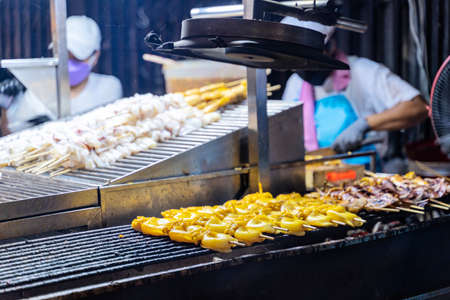 Fresh grilled squids in a street shop along the shore in Bangkok, Thailand.の写真素材