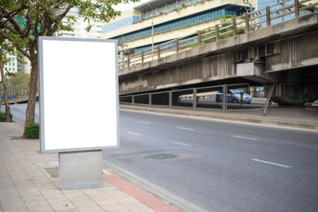 led blank billboard white screen side road in city. ad mockup copy space for advertising banner near bus stop in metropolis.の写真素材