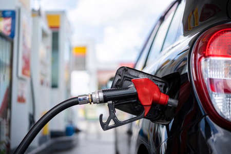 Selective focus Refueling the car with diesel at a gas station. Car refueling on petrol station. Fuel pump at stationの写真素材